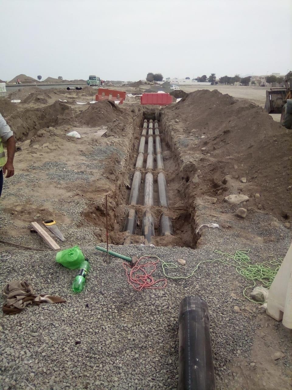 Orange utility ducts laid in a trench