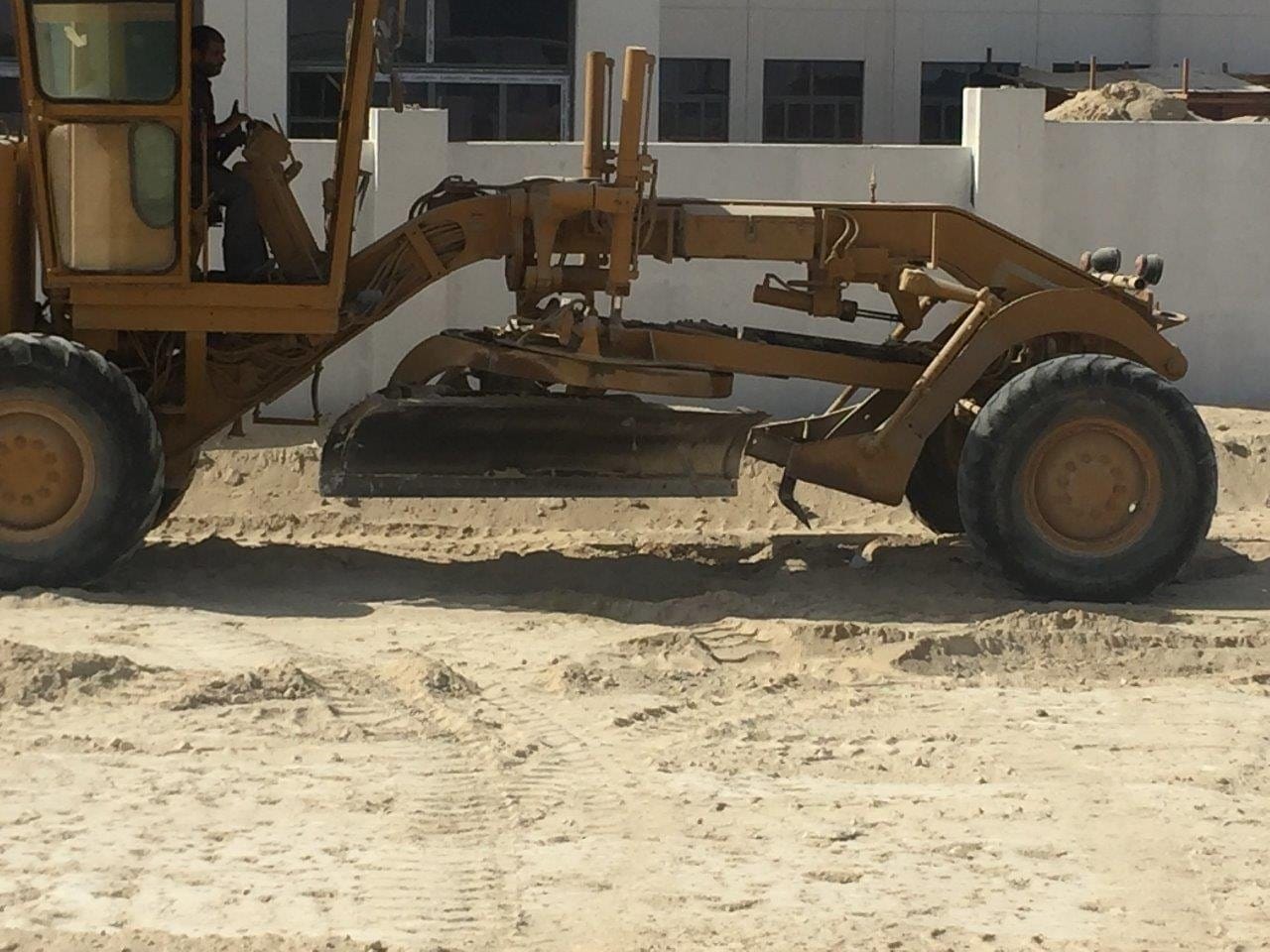 Close view of a motor grader blade on subgrade