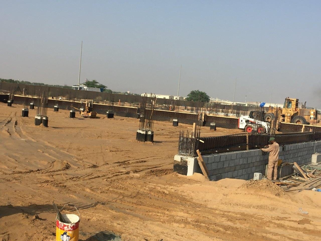 Grader levelling a wide formation area