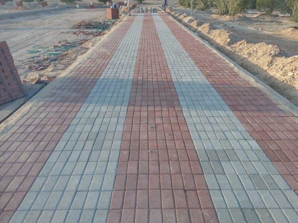 Long avenue paved with red and grey interlock