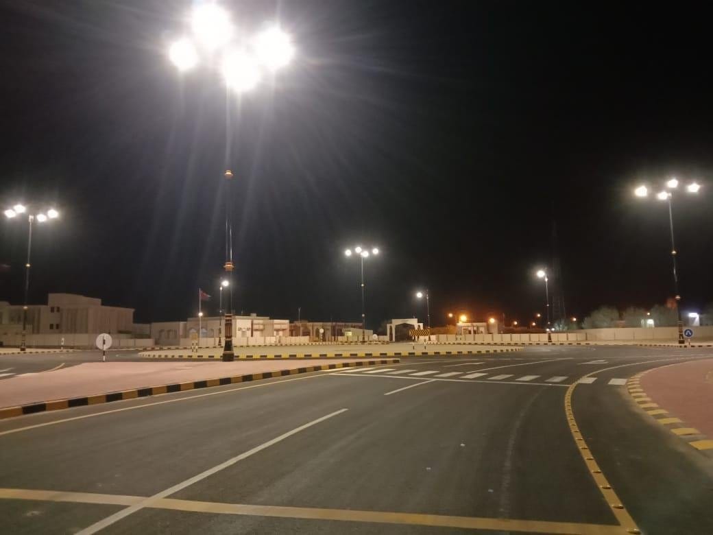 Lit avenue with decorative poles