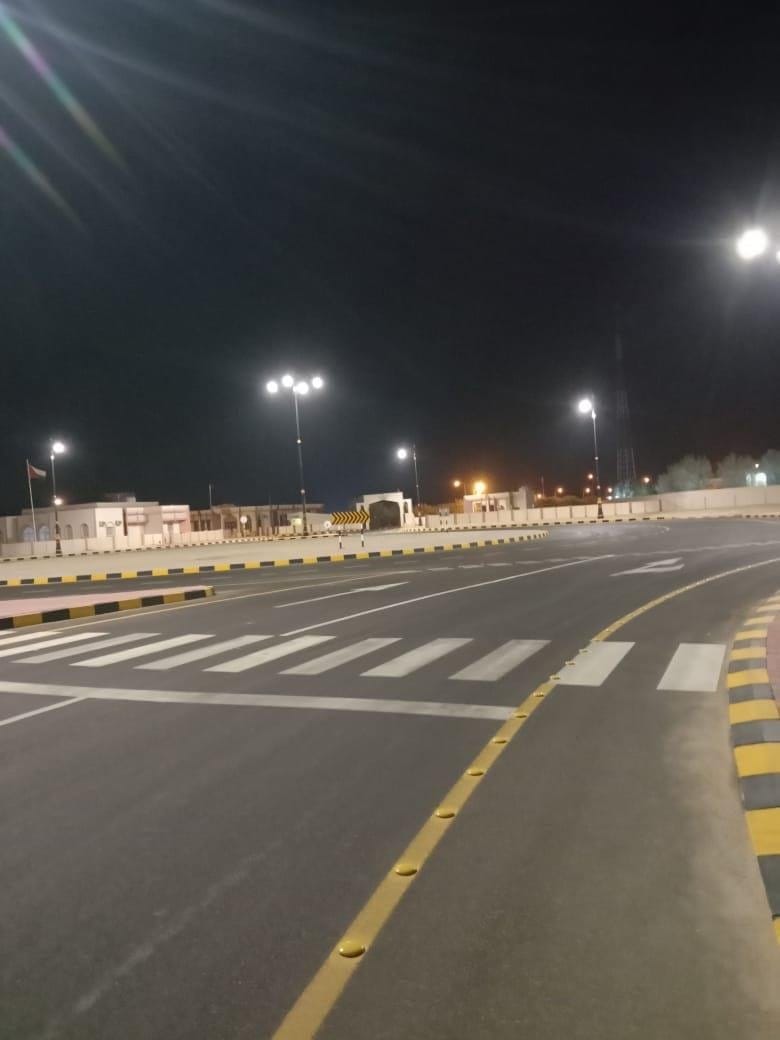 Lit road with pedestrian crossing at night